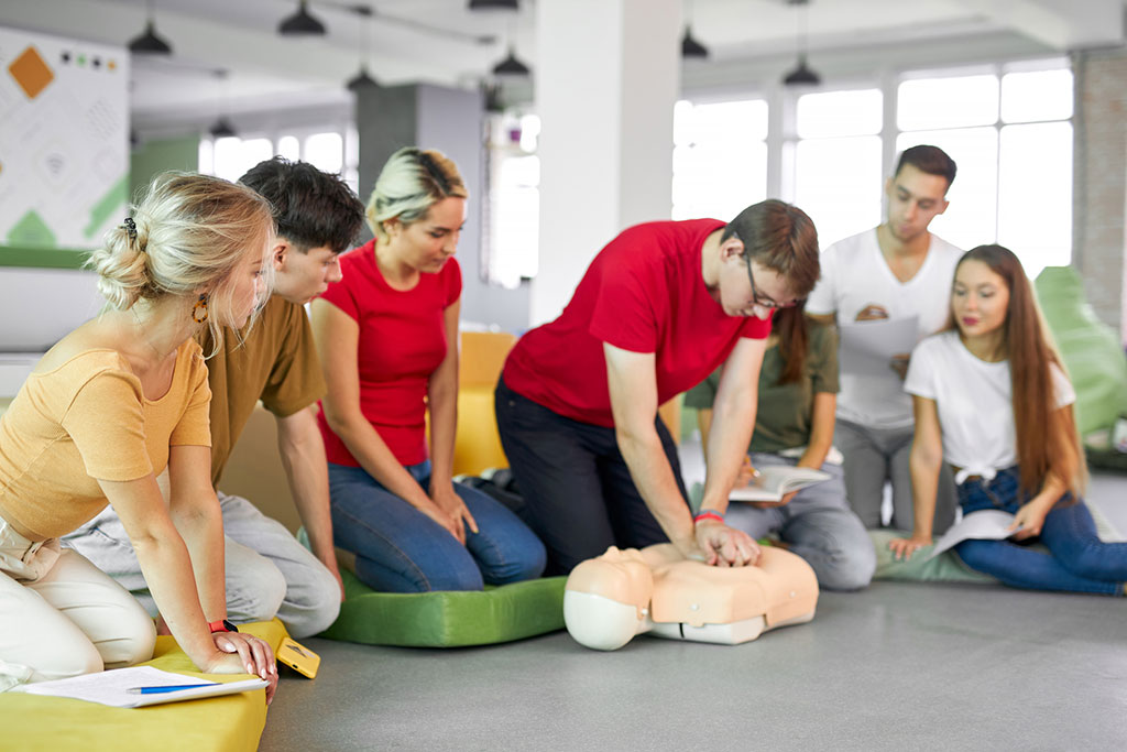 Caucasian people practice an exercise of resuscitation
