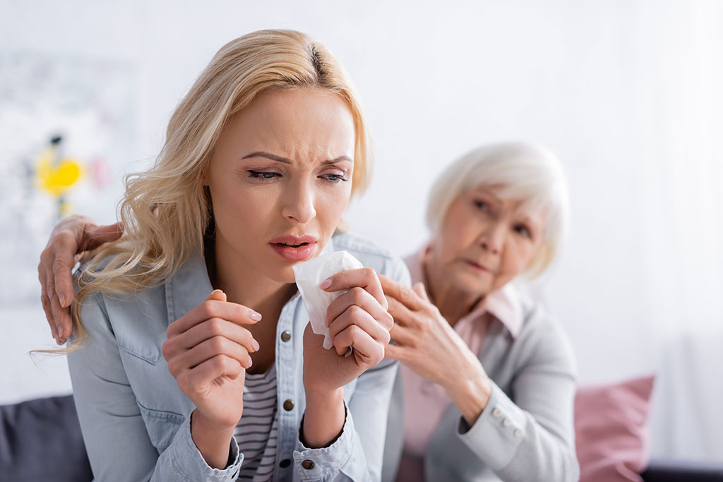 Displeased woman sitting near senior mother