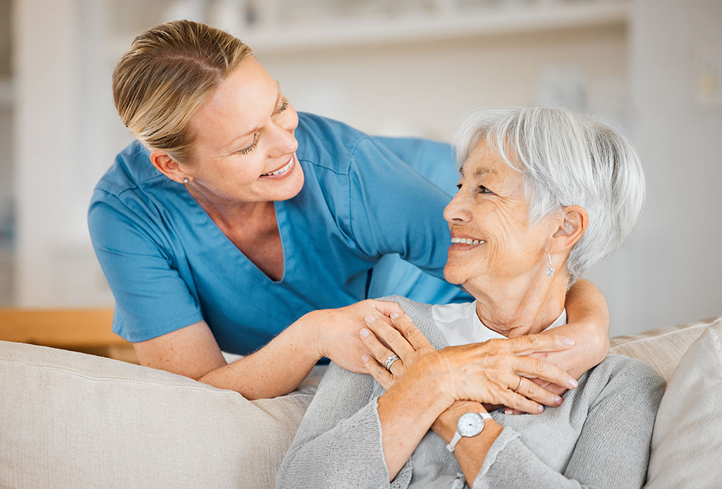 A nurse caring for a senior woman at home.