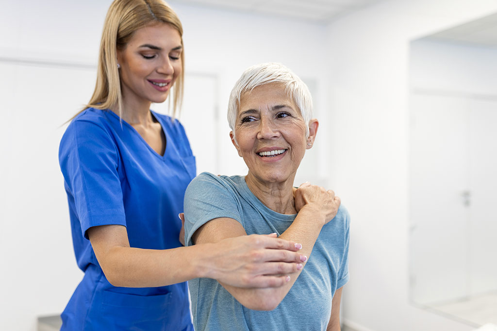 Doctor or Physiotherapist working examining treating injured arm of senior patient, stretching and exercise, Doing the Rehabilitation therapy pain in clinic