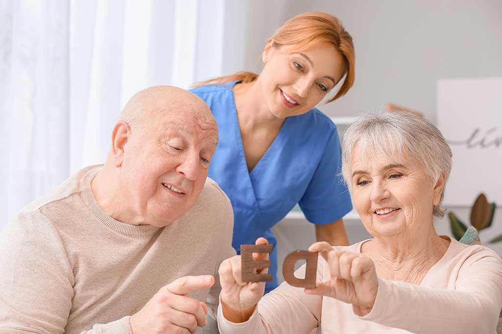 Elderly people suffering from mental disability and caregiver in nursing home